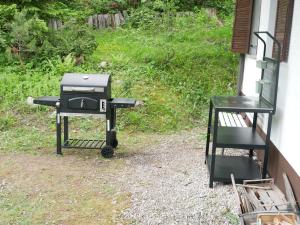 a barbecue grill sitting outside of a house at Chalet Mia in Gozd Martuljek