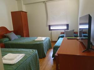 A bed or beds in a room at Hotel Villa De Lerma