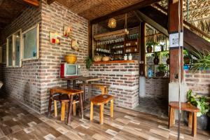 a room with a table and chairs and a tv at Lim's house in Mai Chau