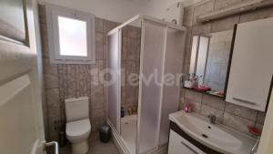 a bathroom with a shower and a toilet and a sink at Sunny Pearl of Cyprus in İskele +6 photos