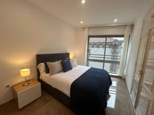 a bedroom with a large bed and a window at REGIDOR Cartagena in Cartagena
