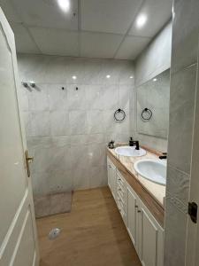 a bathroom with two sinks and two mirrors at REGIDOR Cartagena in Cartagena +36 photos