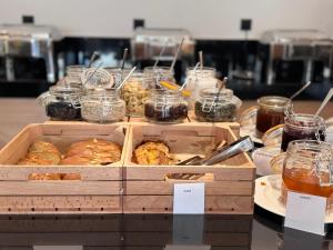 a display of pastries and jars of food on a table at Angela Downtown Hotel in Rhodes Town
