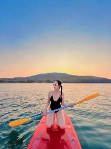 a woman sitting on a kayak in the water at Moonbeam Homestay & Mini-resort Mui Ne in Phan Thiet