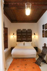 Postel nebo postele na pokoji v ubytování Riad El Morocco Hotel