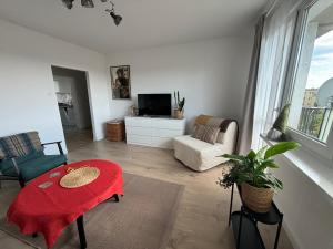a living room with a tv and a couch and a table at Nocleg na doby S 61 ROAD in Suwałki