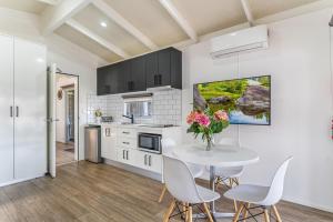 a kitchen and dining room with a table and chairs at BIG4 Tasman Holiday Parks - Warrnambool in Warrnambool