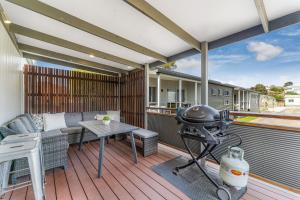a patio with a grill and a table on a deck at BIG4 Tasman Holiday Parks - Warrnambool in Warrnambool
