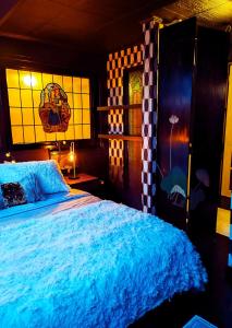 a bedroom with a bed and stained glass windows at Duplex Atypique à Bruxelles in Brussels