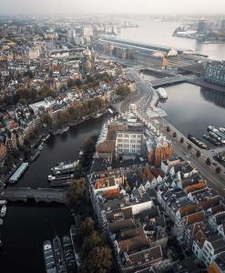 an aerial view of a city with a river and buildings at Boat no Breakfast in Amsterdam