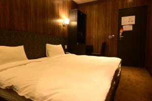 Postel nebo postele na pokoji v ubytování Meworld Hotel - Taipei Main Station
