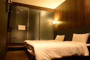 Postel nebo postele na pokoji v ubytování Meworld Hotel - Taipei Main Station