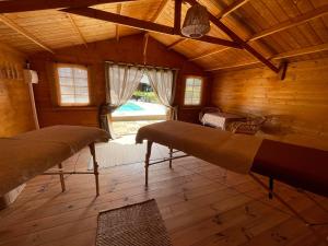 a bedroom with two beds in a wooden cabin at Carpediem_corsica in Poggio-dʼOletta