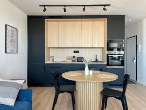 a kitchen with a table and chairs in a room at SmartApartment Prúdy Trnava, Free Parking, 800m CityArena in Trnava