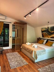 a bedroom with a bed and a large window at Blisku do Gradot - Riverfront Luxury Cabins in Skopje +126 photos