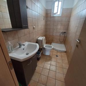 a bathroom with a sink and a toilet at Central Rooms in Makry Gialos +40 photos