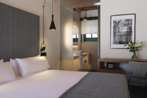 a hotel room with a bed and a sink at Hotel El Rosal de Cudillero in Cudillero
