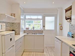 a kitchen with a sink and a window at Valetta Park in Emsworth
