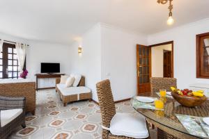 a living room with a table and chairs at OkStay Apt Bencomo 50 m from the beach in Puerto de la Cruz