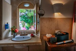 a bathroom with a sink and a window at Terre Di Vendicari in Noto