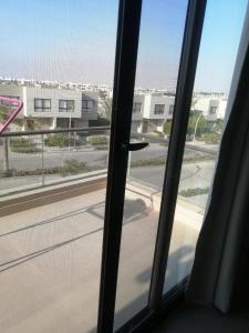 a sliding glass door with a view of a street at Premium Sea View Chalet in Azha Ain Sokhna in Ain Sokhna