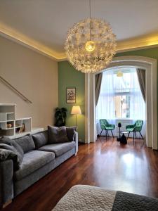 a living room with a couch and a chandelier at Apartment Exclusive View Cvjetni trg in Zagreb