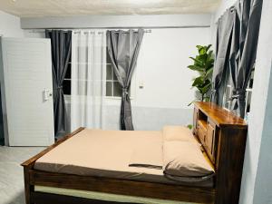 a small bed in a room with a window at The SD Apartment in Camiling