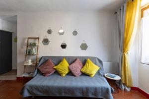 a bedroom with a couch with four pillows on it at Le cosy in Marseille