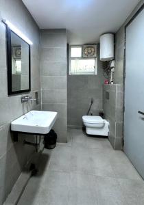 a bathroom with a sink and a toilet at Nidra Hotel in New Delhi