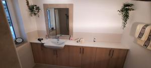 a bathroom with a sink and a mirror at Green Garden , HOMEANDSAIL in Jezera +28 photos