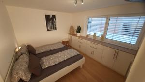 a small bedroom with a bed and a window at Green Garden , HOMEANDSAIL in Jezera
