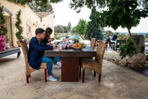 a man and a woman sitting at a table at Terre Di Vendicari in Noto
