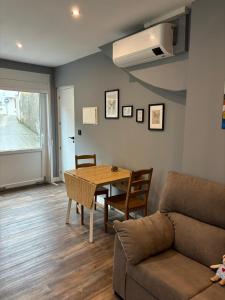 a living room with a table and a couch at NOARU Apartamentos in Ares
