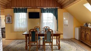 a dining room with a wooden table and chairs at FreiNestWaldviertel in Hoheneich