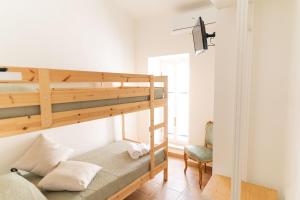 a bedroom with a bunk bed and a chair at La casetta in Tortoreto Lido