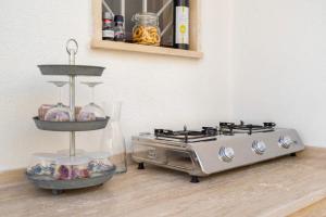 a kitchen with a stove and a shelf with food at Secret Garden Chalet No. 1 in San Pietro in Bevagna