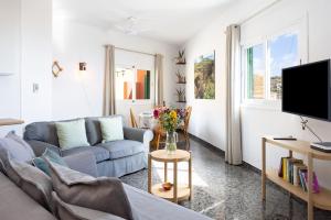 a living room with a couch and a tv at OkStay Casa Maye Tenerife with jacuzzi and large outdoor area in Güimar