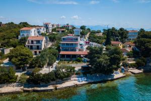 una vista aérea de un complejo sobre el agua en Boutique Guesthouse Sveti Petar, on the beach, heated pool, restaurant & boat berth - ADULT ONLY, en Nečujam