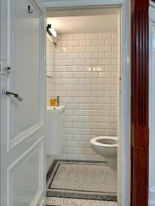 a bathroom with a toilet and a glass door at Your homestay in a bibliophile mansion in Antwerp