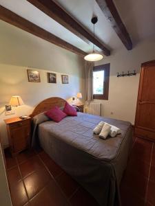 a bedroom with a bed with two towels on it at Hostal Centre Del Montsec in Llimiana