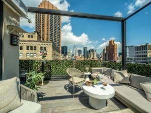 a patio with a couch and a table on a balcony at The Marmara Park Avenue in New York