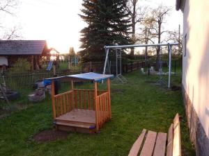 a playground in a yard with a play structure at Hilma in the holiday home Bero in Bärenwalde