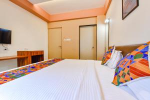 a bedroom with a bed and a television in it at FabHotel Peak Stay in Porvorim