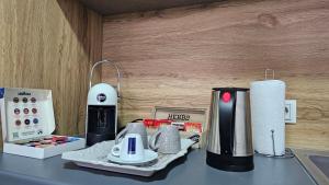 a kitchen counter with a coffee maker on a table at Superb 1 bedroom in the best zone of the city. in Ferizaj