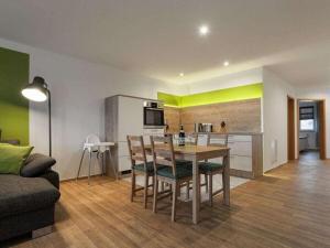 a kitchen and living room with a table and chairs at Strandeck Zuidstrand in Göhren