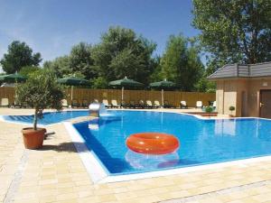 a large swimming pool with a red seat in it at Mobile home "Romantic Suite" M 160 in Fehmarn