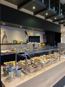 a bakery with many different types of pastries on display at ibis budget Lugano Paradiso in Lugano