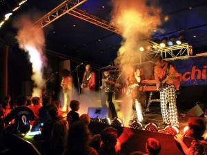 a band performing on a stage in front of a crowd at on the beach no 991 in Wulfen auf Fehmarn +13 photos
