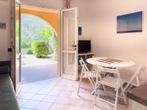 a room with a table and chairs and an open door at Appartamento Stefania Località Nisportino in Rio nellʼElba +29 photos