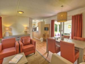 a living room with a table and a dining room at - The "Ocala" mobile home in Fehmarn